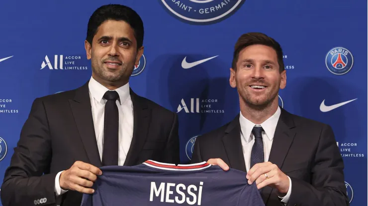 PARIS, FRANCE – AUGUST 11: Lionel Messi poses with his jersey next to President Nasser Al Khelaifi after the press conference of Paris Saint-Germain at Parc des Princes on August 11, 2021 in Paris, France. (Photo by Sebastien Muylaert/Getty Images)
