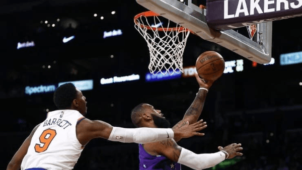 Foto: Ronald Martinez/Getty Images - LeBron James passa por RJ Barrett